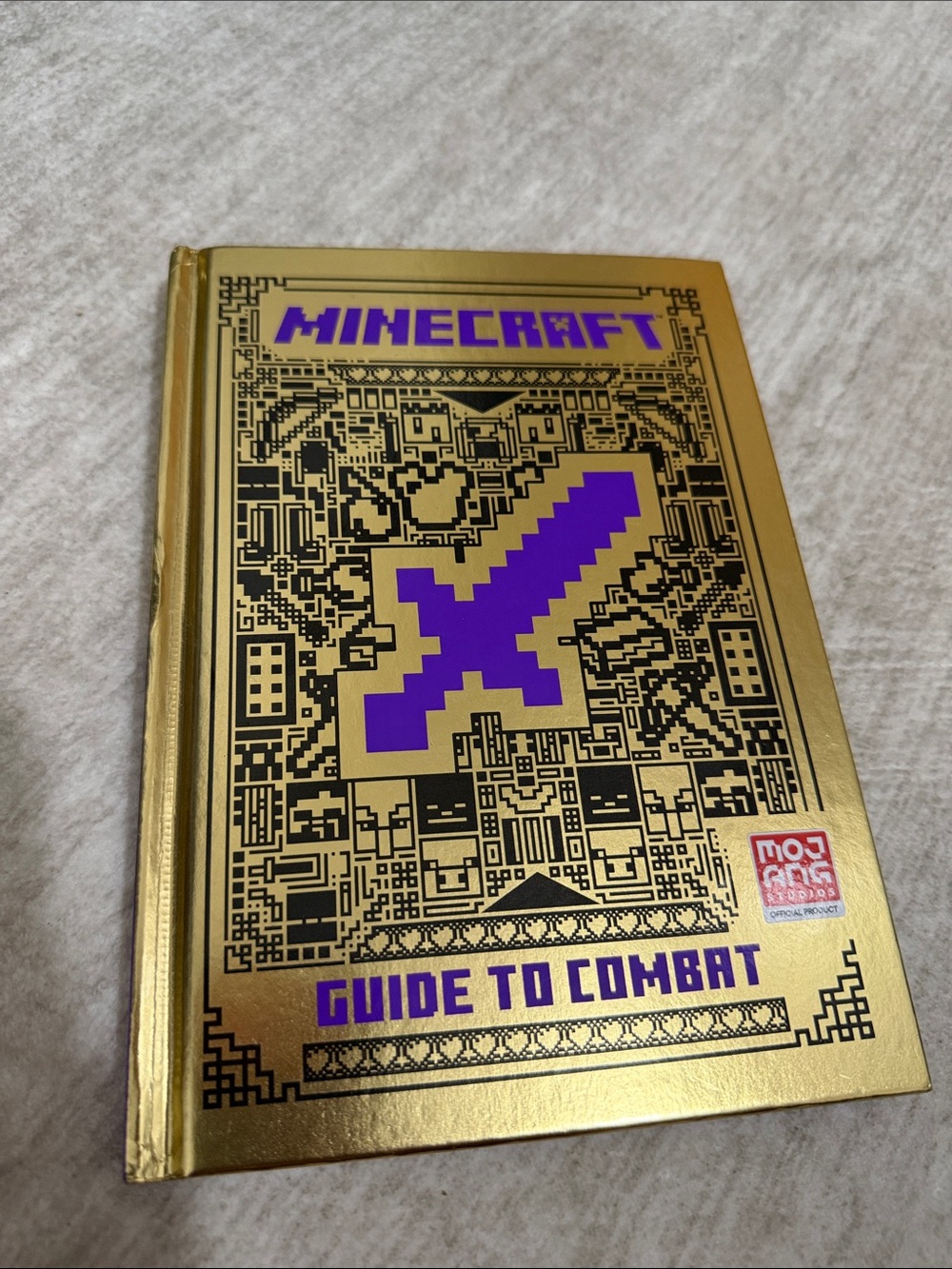 Guide to Combat — Gold Cover with Purple Accents